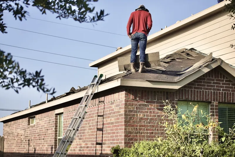 Professional roofer working on a residential roof in Midland Park